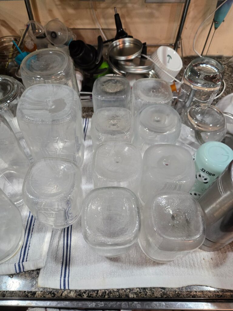 I received a bunch of these old jars from someone who stored them in a garage. I have soaked them in hot water & vinegar for 24 hours (2x) and they still keep coming out like this. Any suggestions?