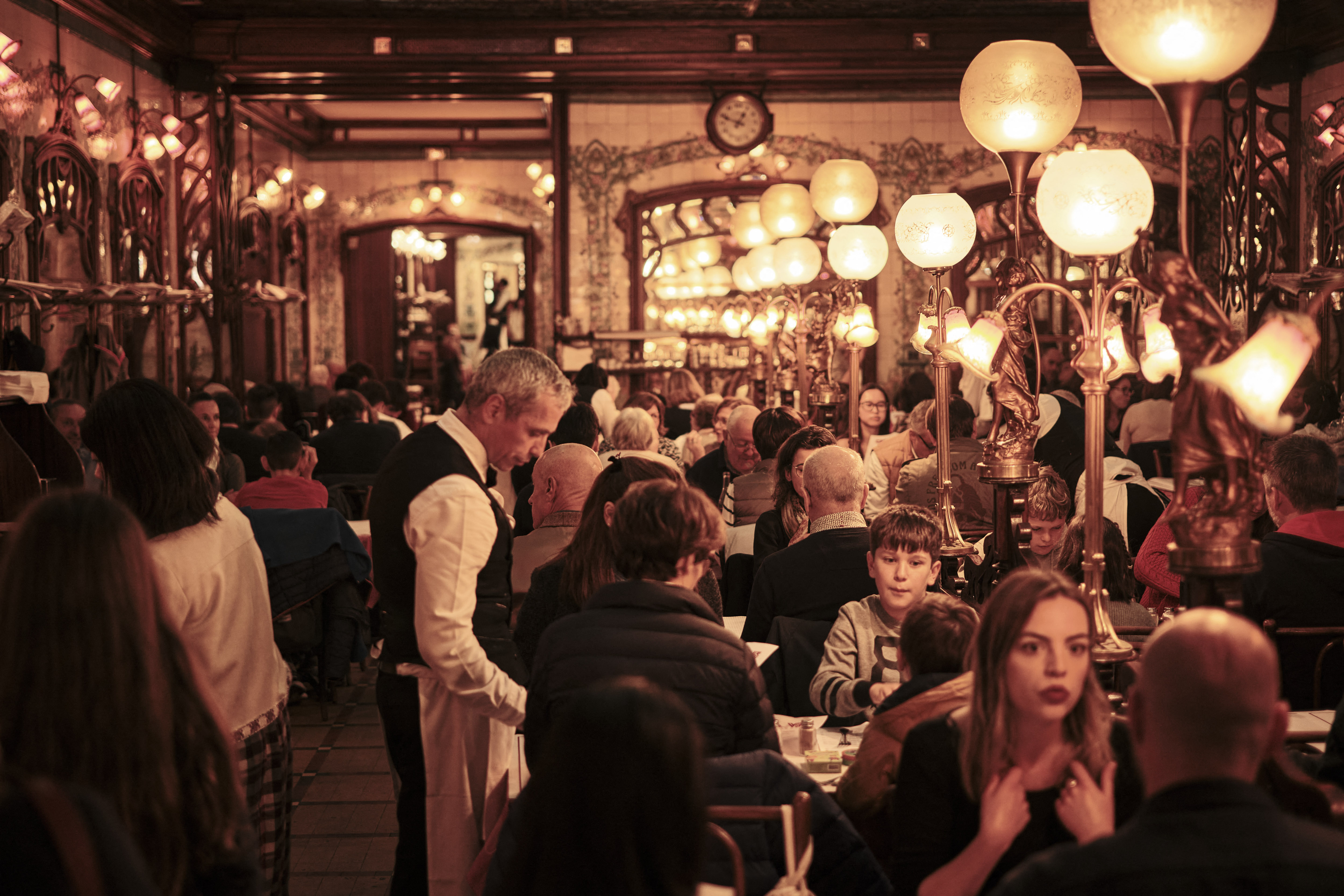 Interior of a busy Art Nouveau restaurant in Paris.