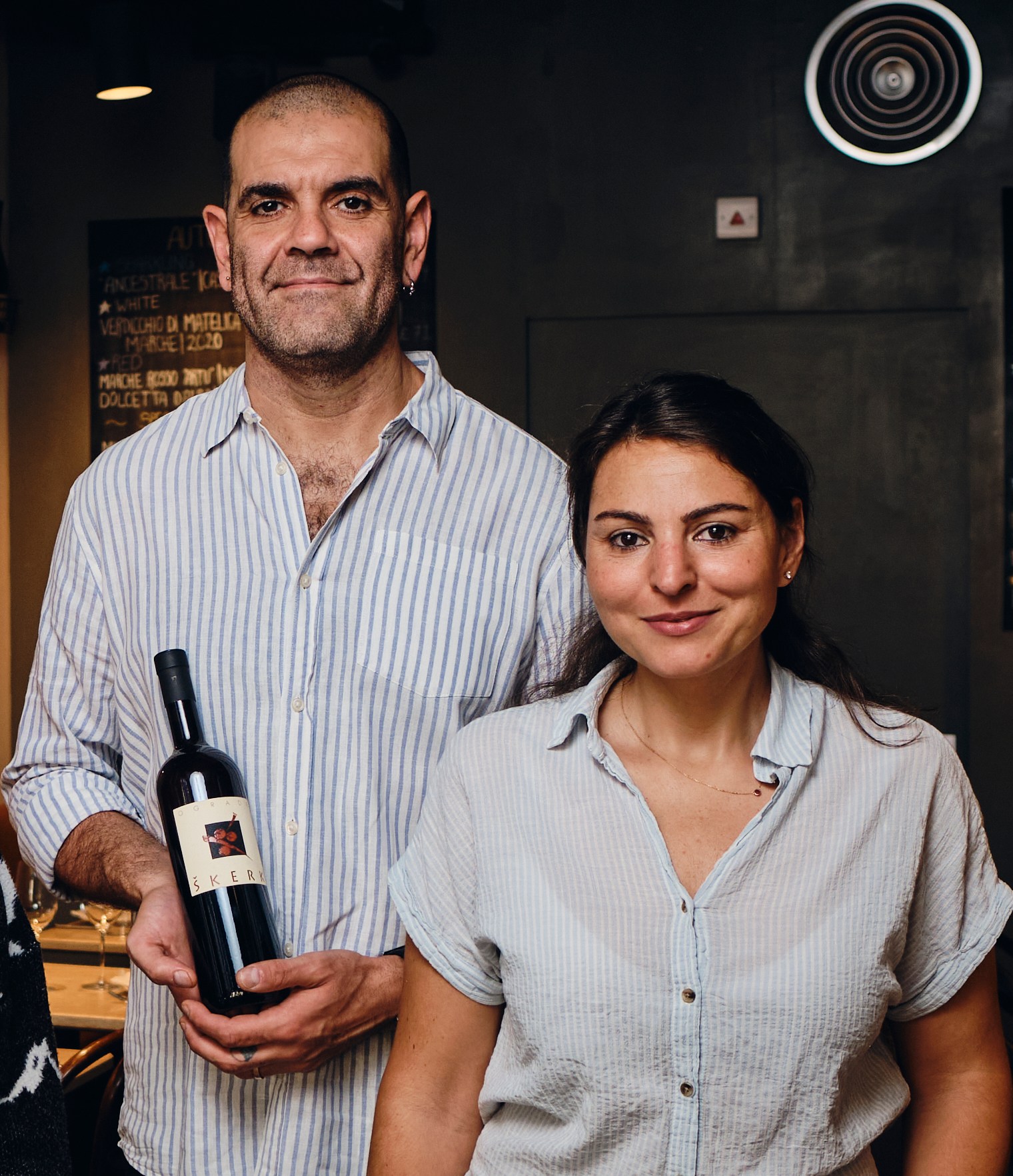 Moreno Polverini, Elif Taner Polverini, Fabio De Nicola, and Ilanit Ovadya posing for a photo, with Moreno and Fabio holding bottles of wine.