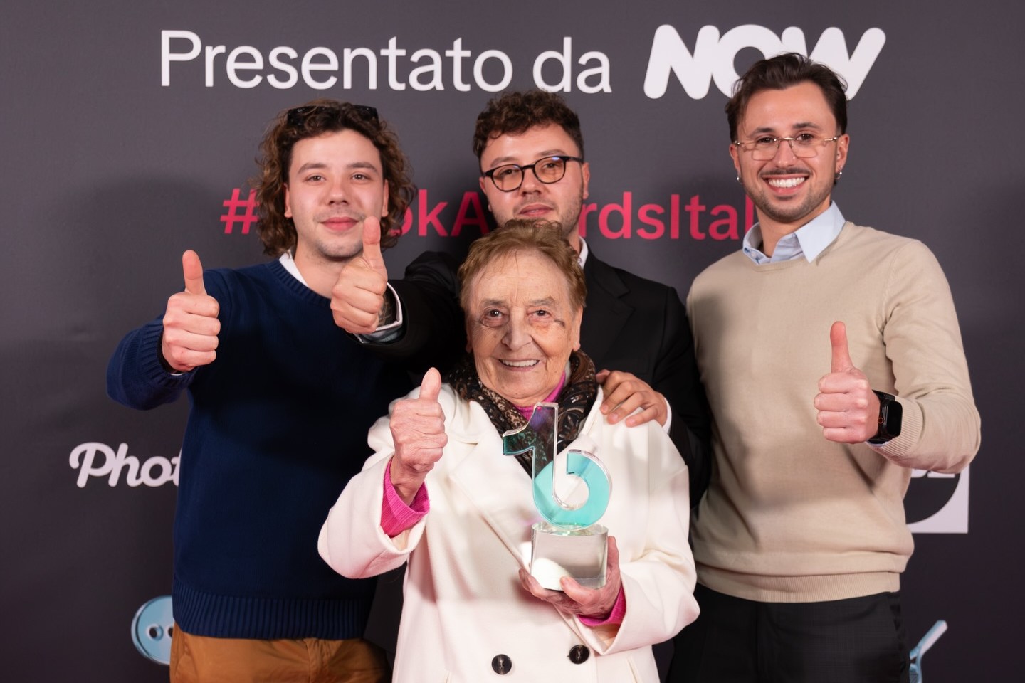 Nonna Silvi with three men at an awards ceremony.