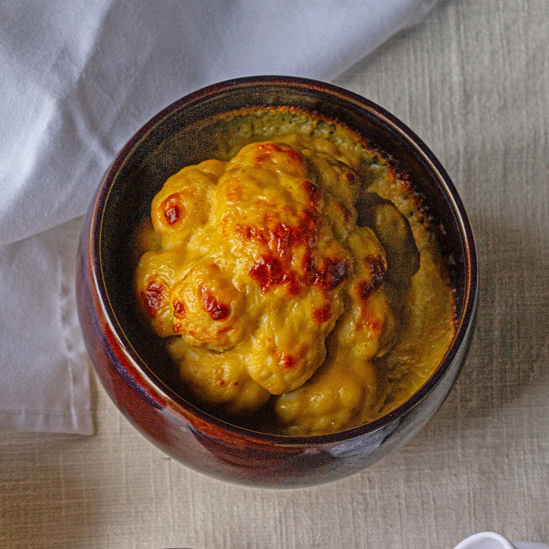 Overhead view of Ruth Hansom's roast recipes, including roast potatoes, mashed carrots, cauliflower cheese, and minty peas.