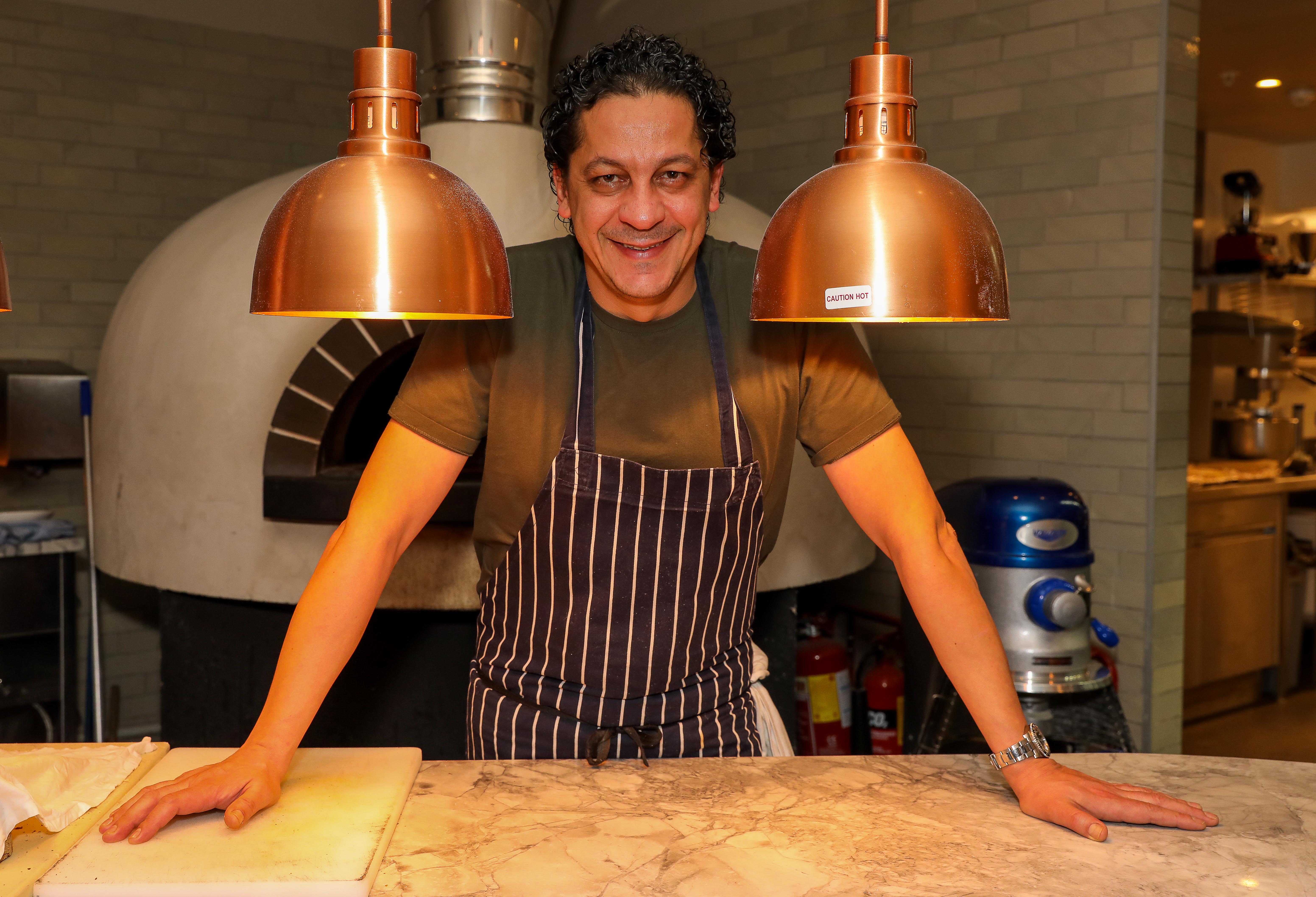 Francesco Mazzei smiling at the launch of "The Dirty Dishes" cookbook.