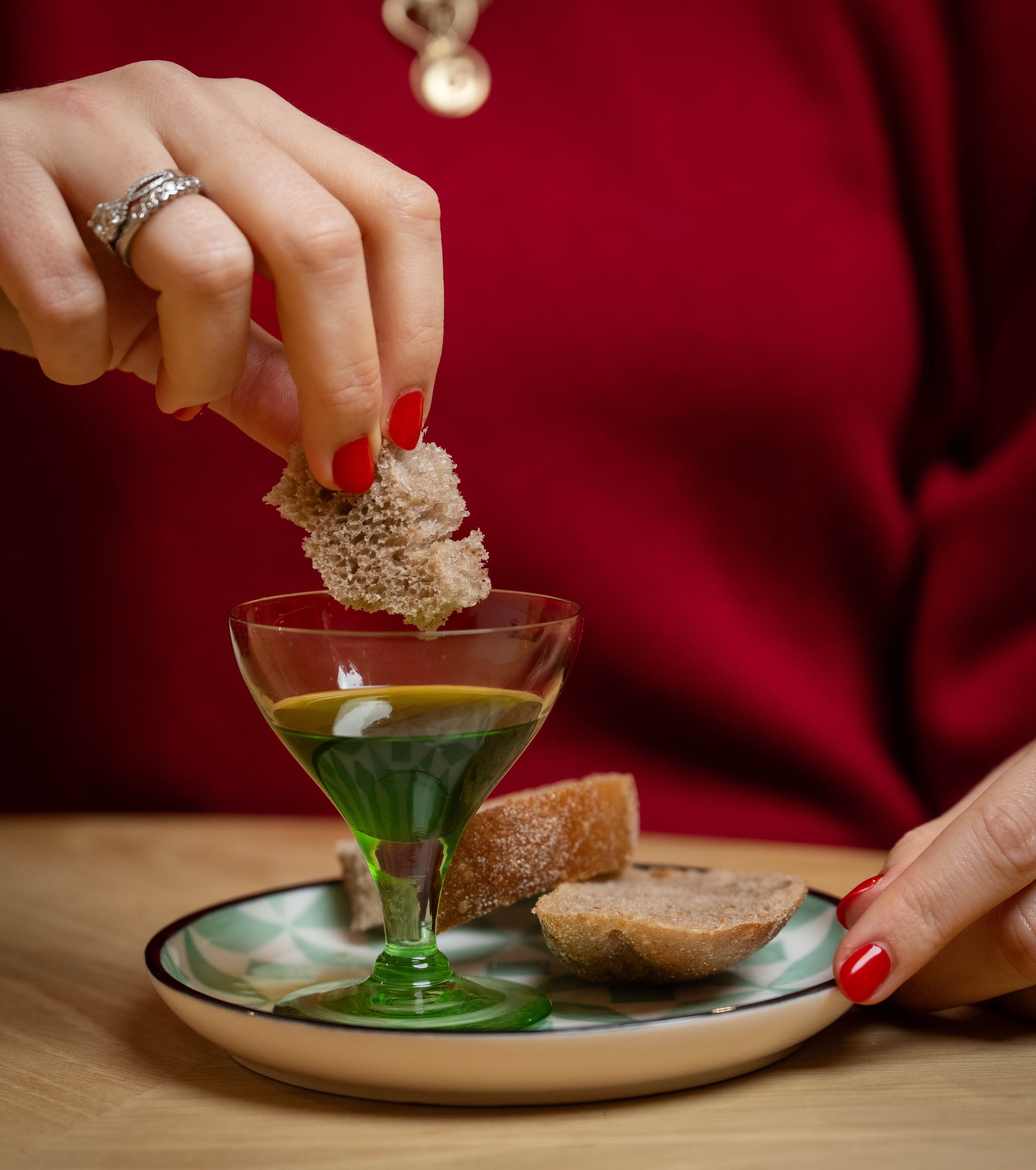 Giulia Crouch dipping bread into English extra virgin olive oil.