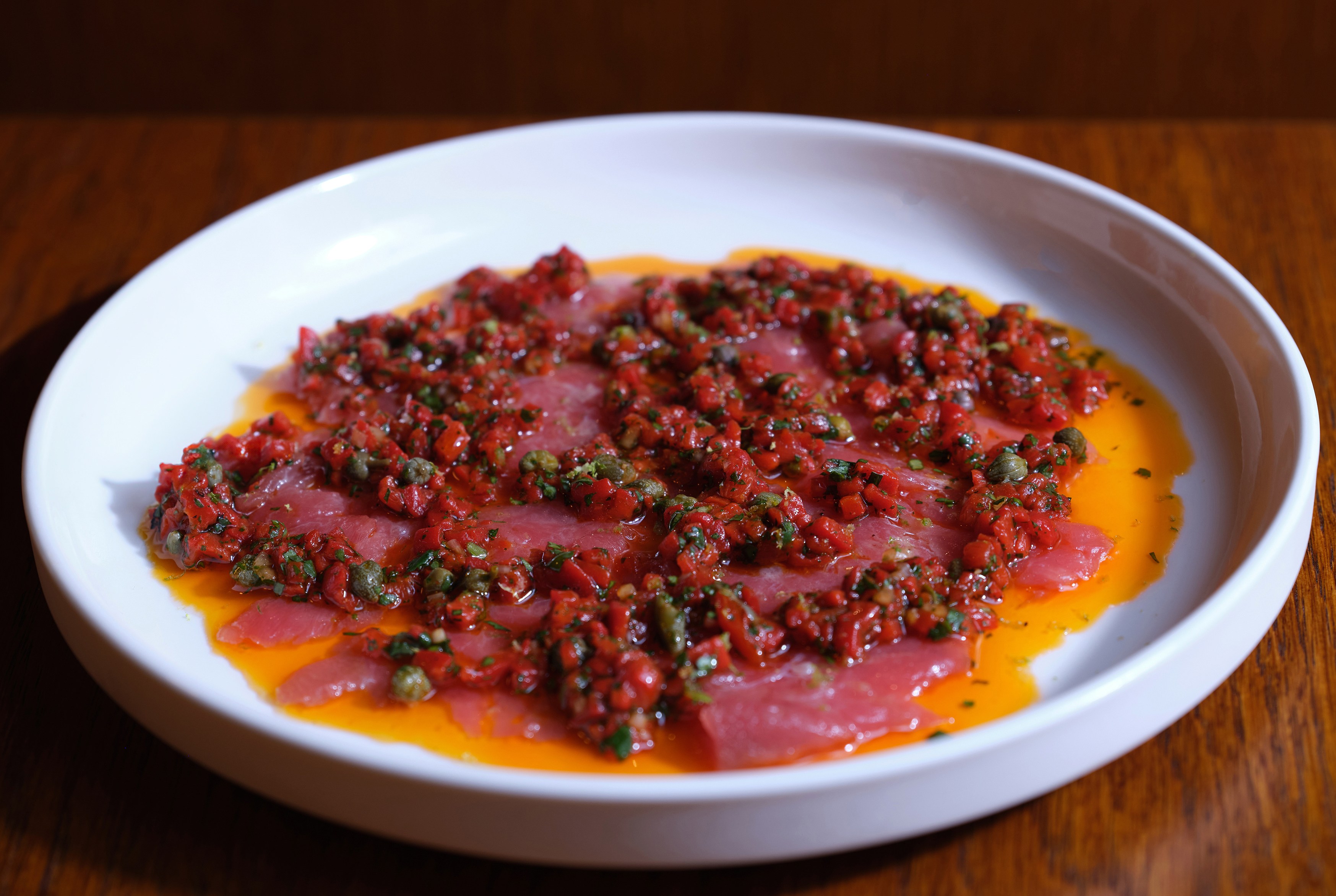 Bluefin Tuna Carpaccio, corno peppers, coriander, sudachi.