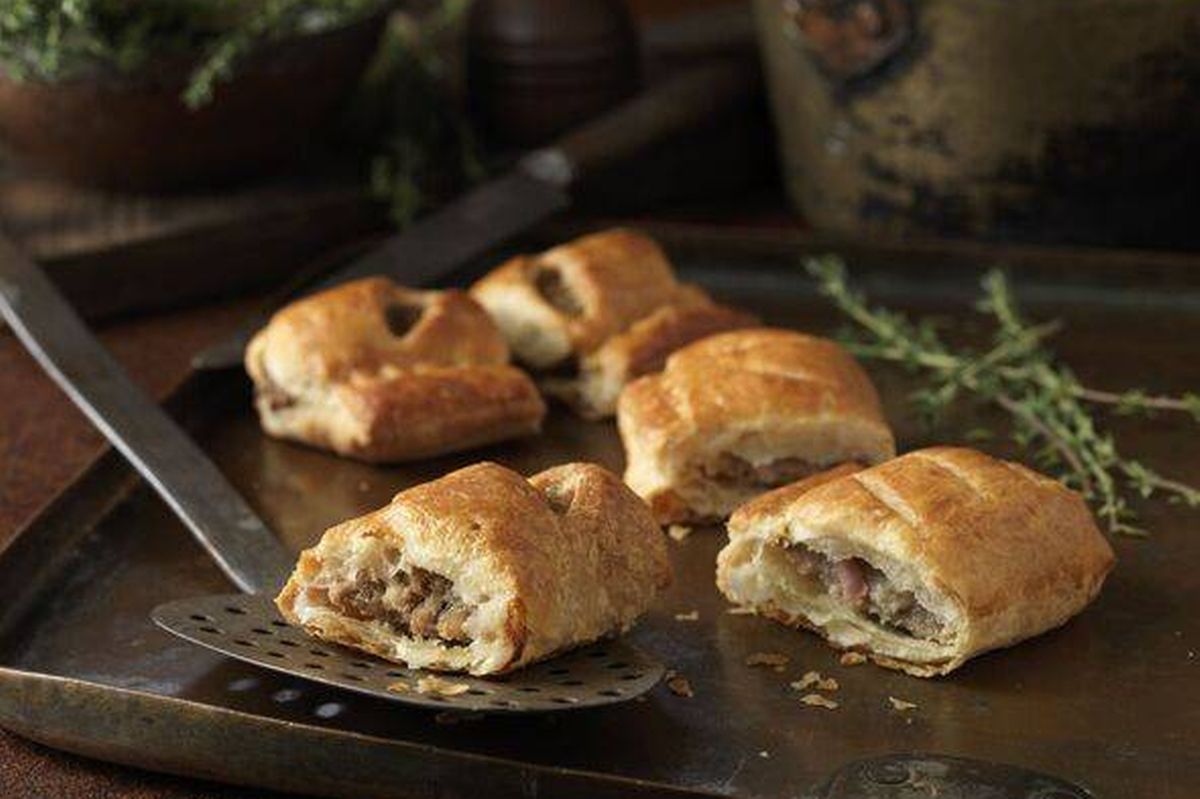 Christmas snack of gourmet sausage rolls and thyme leaves