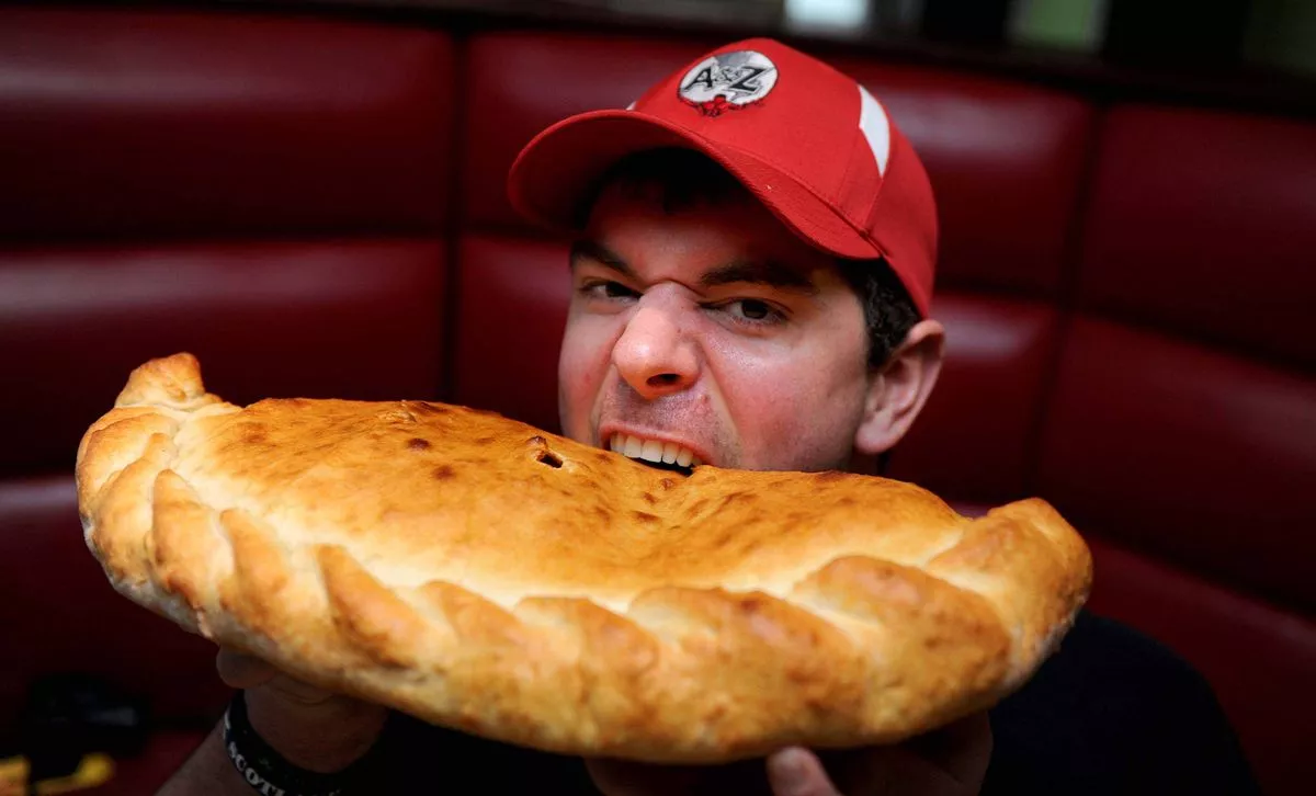 Randy Santel doing the Calzone Challenge at Amalia Italian bar Pizzeria on Campbell Square, Liverpool.