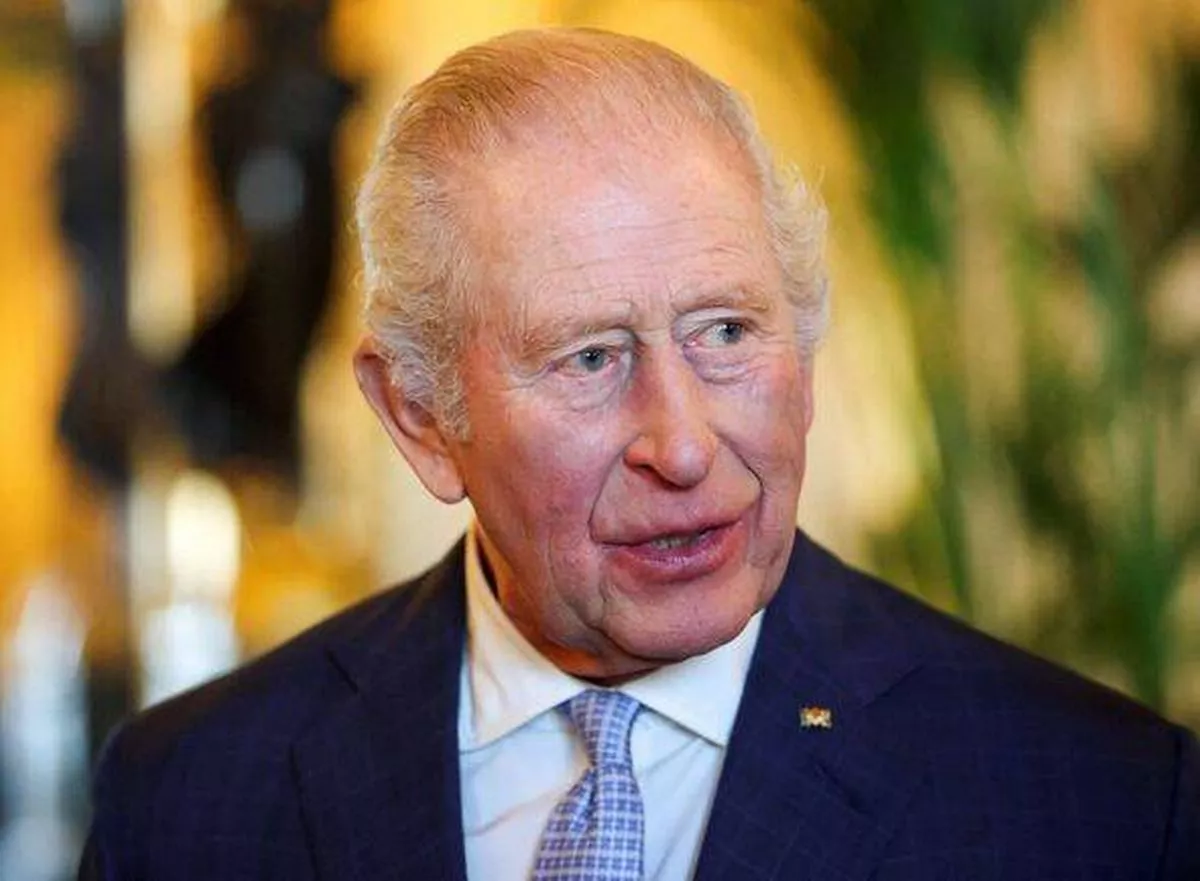 WINDSOR, ENGLAND - DECEMBER 3: King Charles III reacts as he views items on display relating to Germany during a visit to the Ro