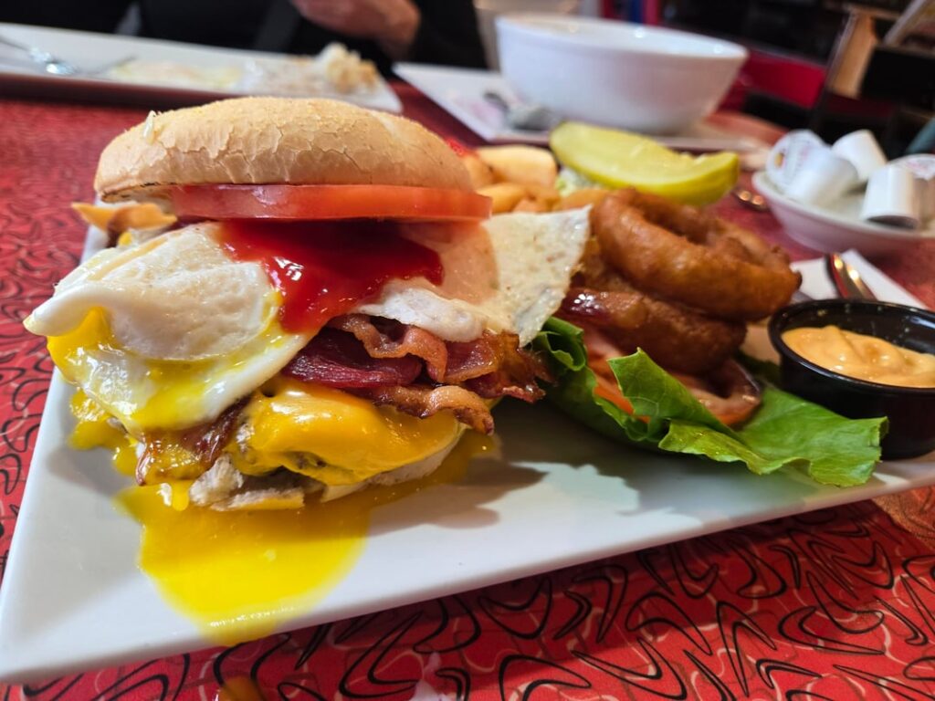 Bacon egg cheeseburger and a bowlmof buscuits drowned in suasage gravy at local diner