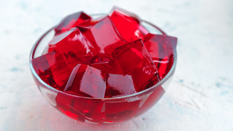 Cubes of red jello in a glass bowl