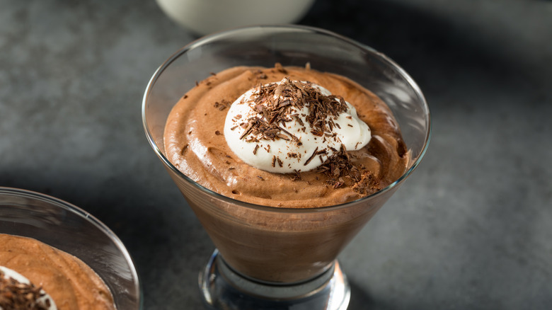 Chocolate mousse in a glass dish on dark grey table