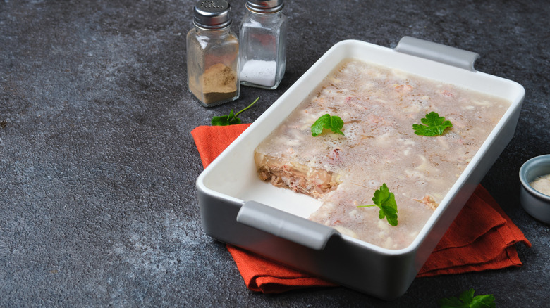 aspic with turkey and pork in a rectangular ceramic dish