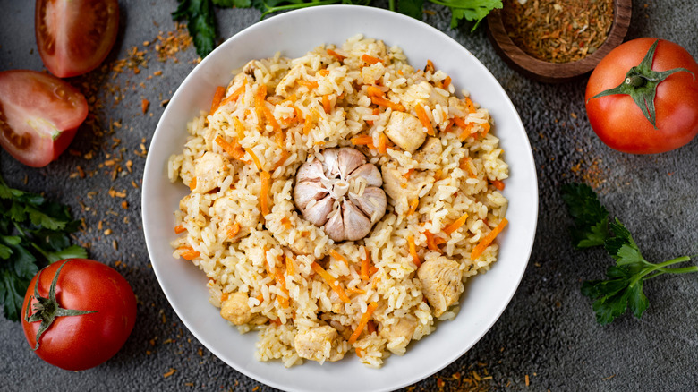 Pilaf with chicken and garlic in a white plate