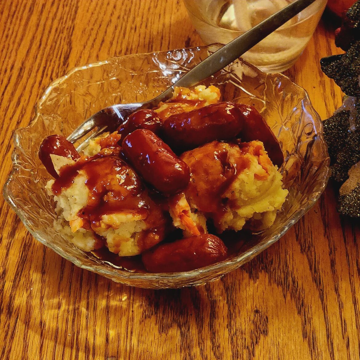 Slow Cooker BBQ Sauce Raspberry Jam Cocktail Sausages served on Gold Potato Baby Carrot Mash
