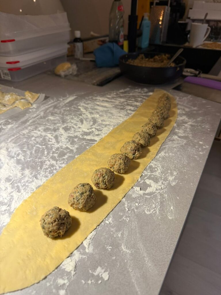 Agnolotti piemontesi with parmezan cream and baked bread crumbs