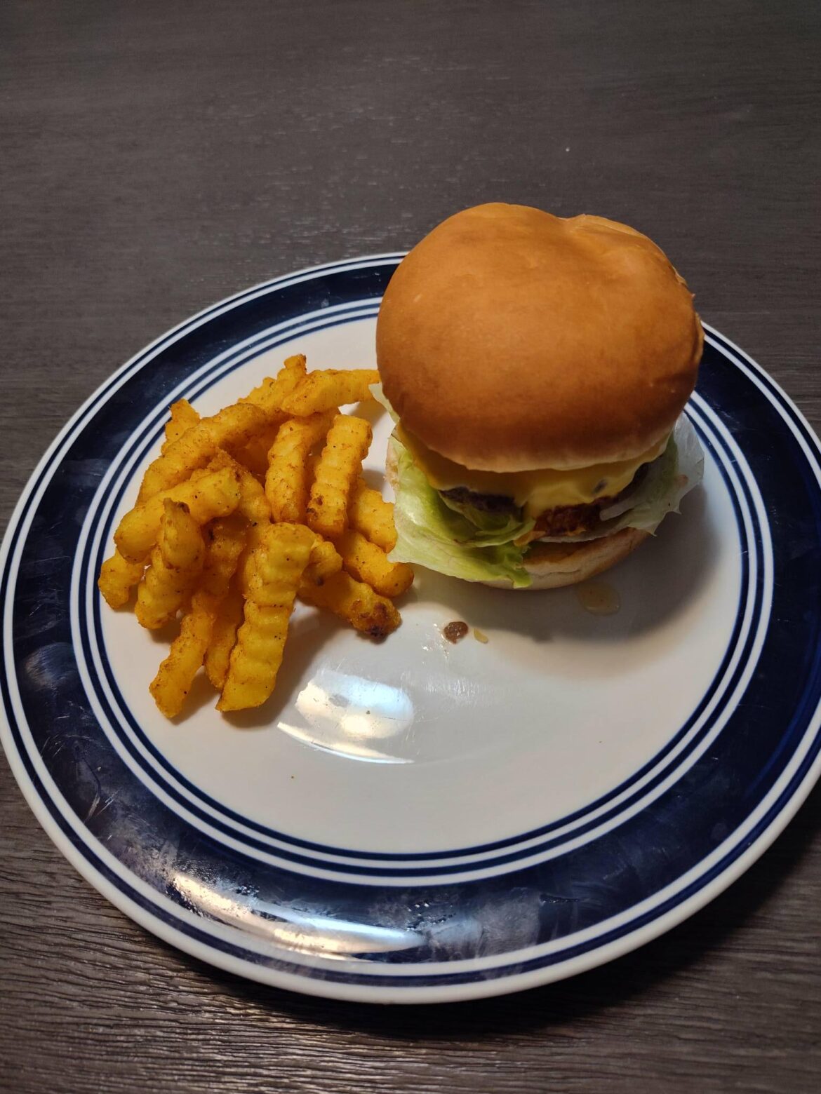 Homemade deluxe cheeseburger with crinkle french fries