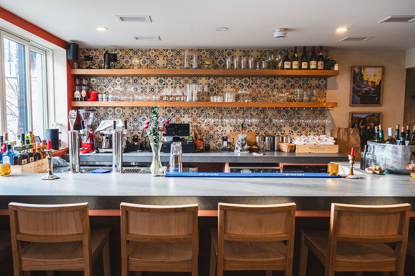 A bar filled with wine glasses.