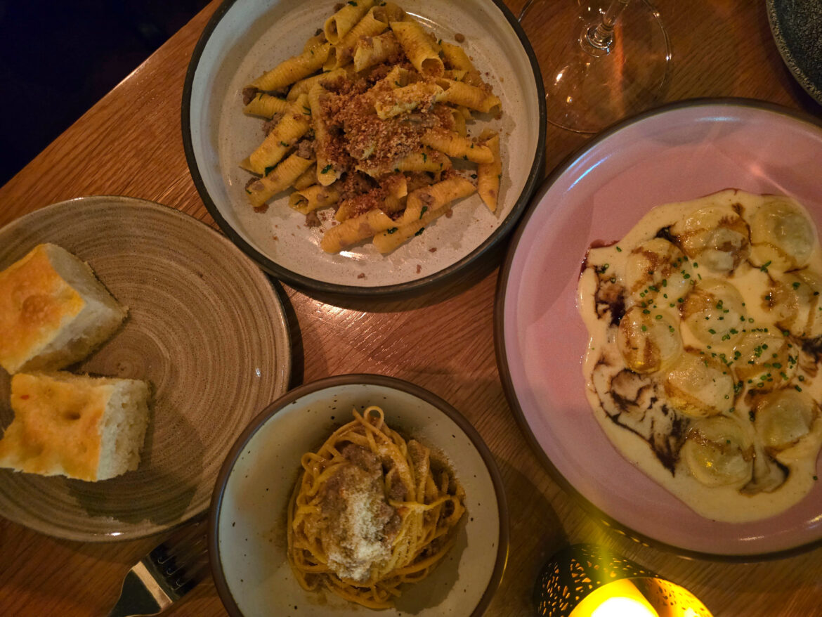three pasta dishes on a table