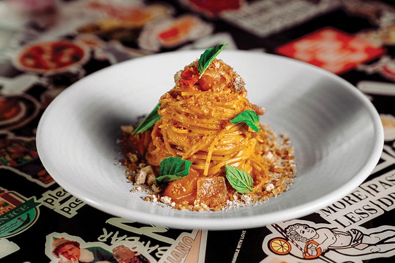 Spaghetti with Umami Bomb tomatoes, charred onion, belper knolle (a hard Swiss cheese) and garlic breadcrumbs at Bar Mutz in Westwood, New Jersey