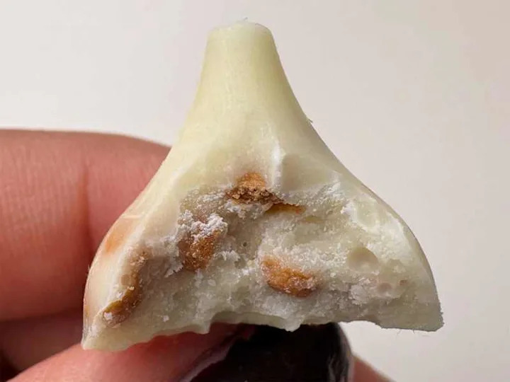 Bite taken out of Snickerdoodle Hershey's kisses.