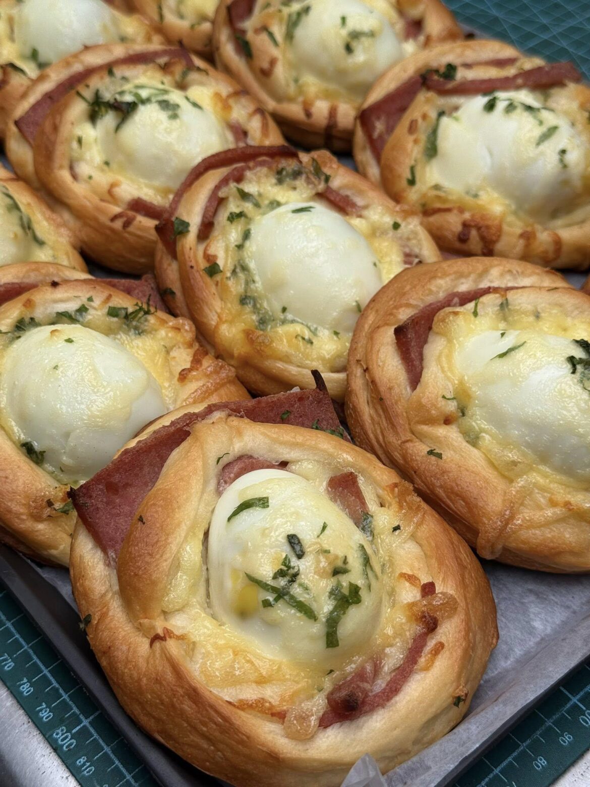 Homemade enriched dough rolls filled with cheese, cured meat, and a baked egg. Shaping was fun, eating them was even better.