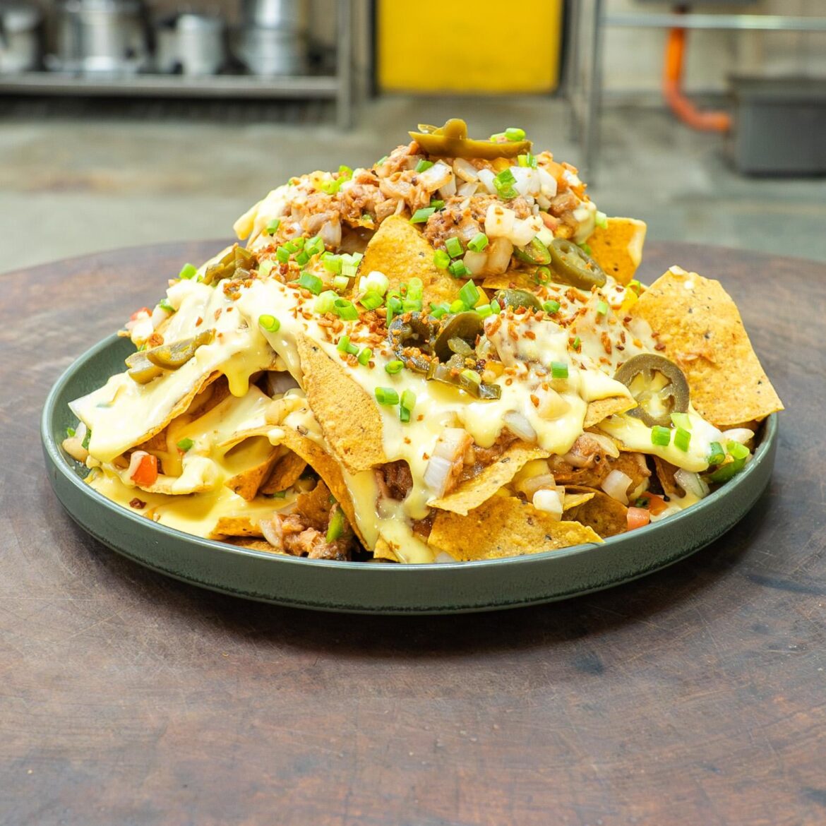 Loaded Nachos with Melted Cheese, Pulled Pork, Jalapeños, Pico de Gallo, and Scallions [OC]