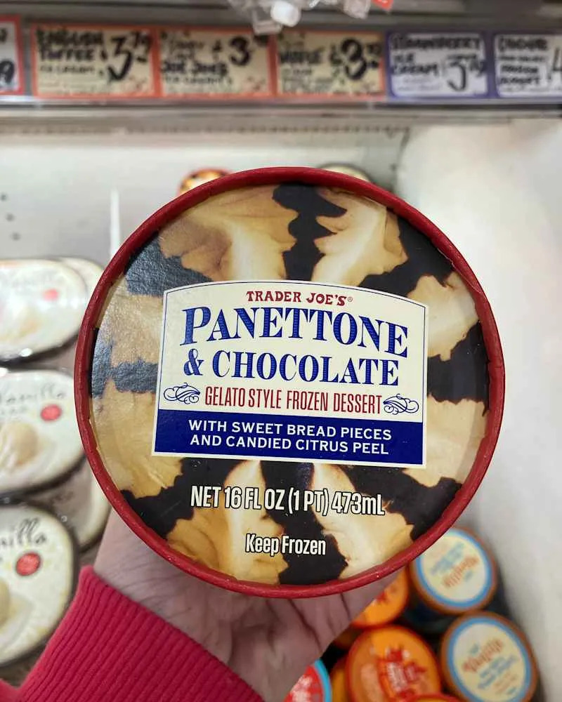 Someone holding carton of Trader Joe's Panettone and Chocolate gelato.