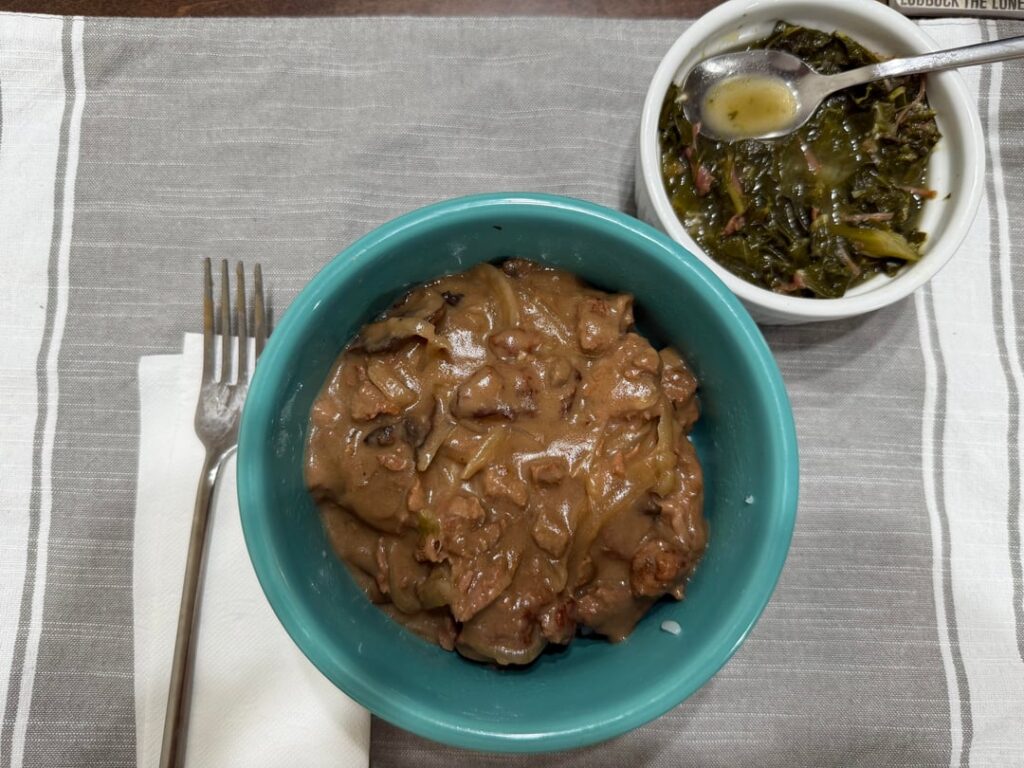 Beef with onion and mushroom gravy, side of collard greens with smoked turkey