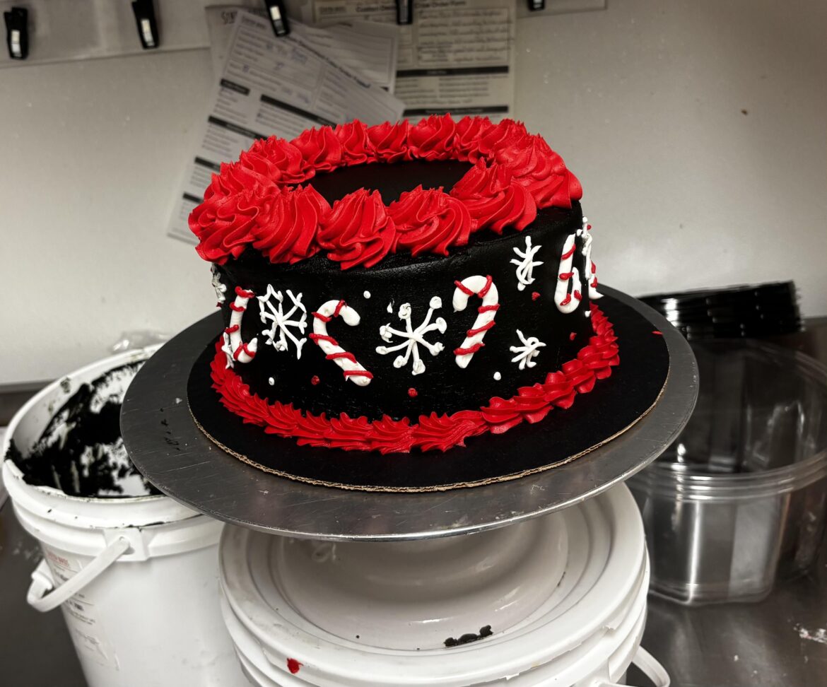 Grocery store decorator learning to draw on cakes