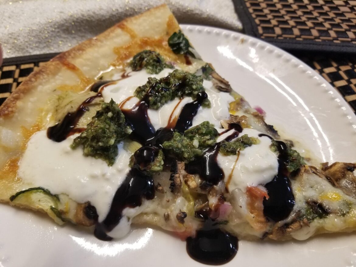 Pizza with burrata, pesto and balsamic glaze