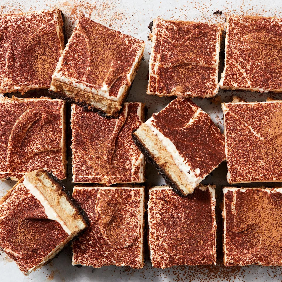 tiramisu cheesecake bars with espresso powder on top