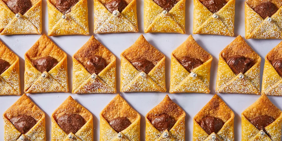 letter shaped pastries filled with chocolate and cinnamon sugar on a plate with milk