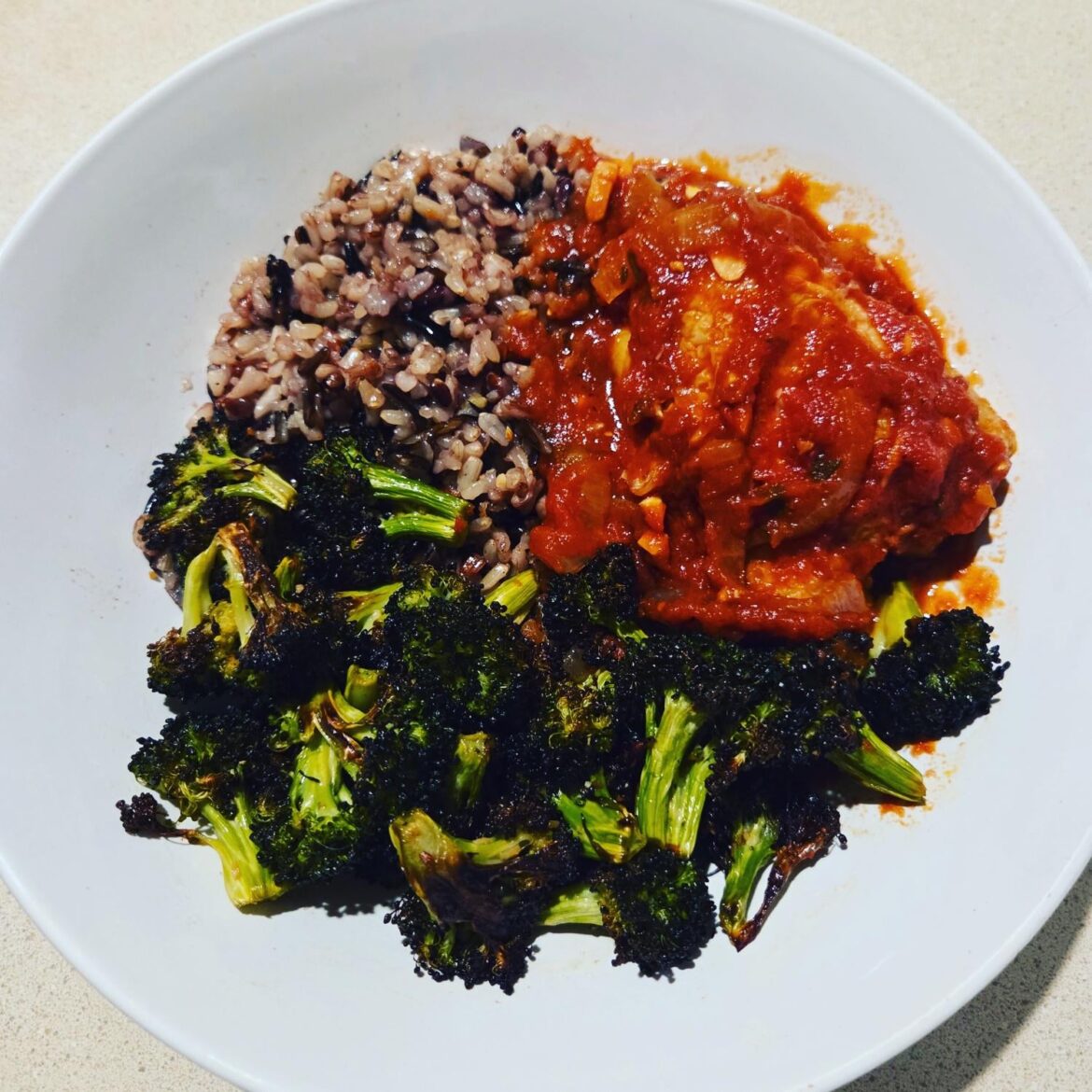 Tomato braised chicken thighs, wild rice, and garlic roasted broccoli.