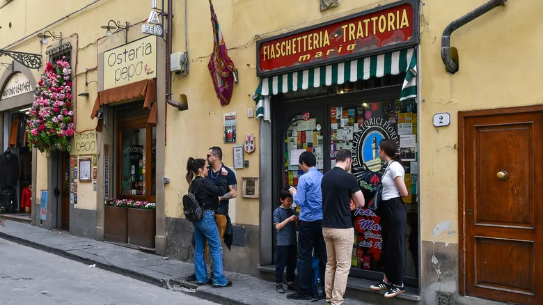 Customers standing outside a trattoria