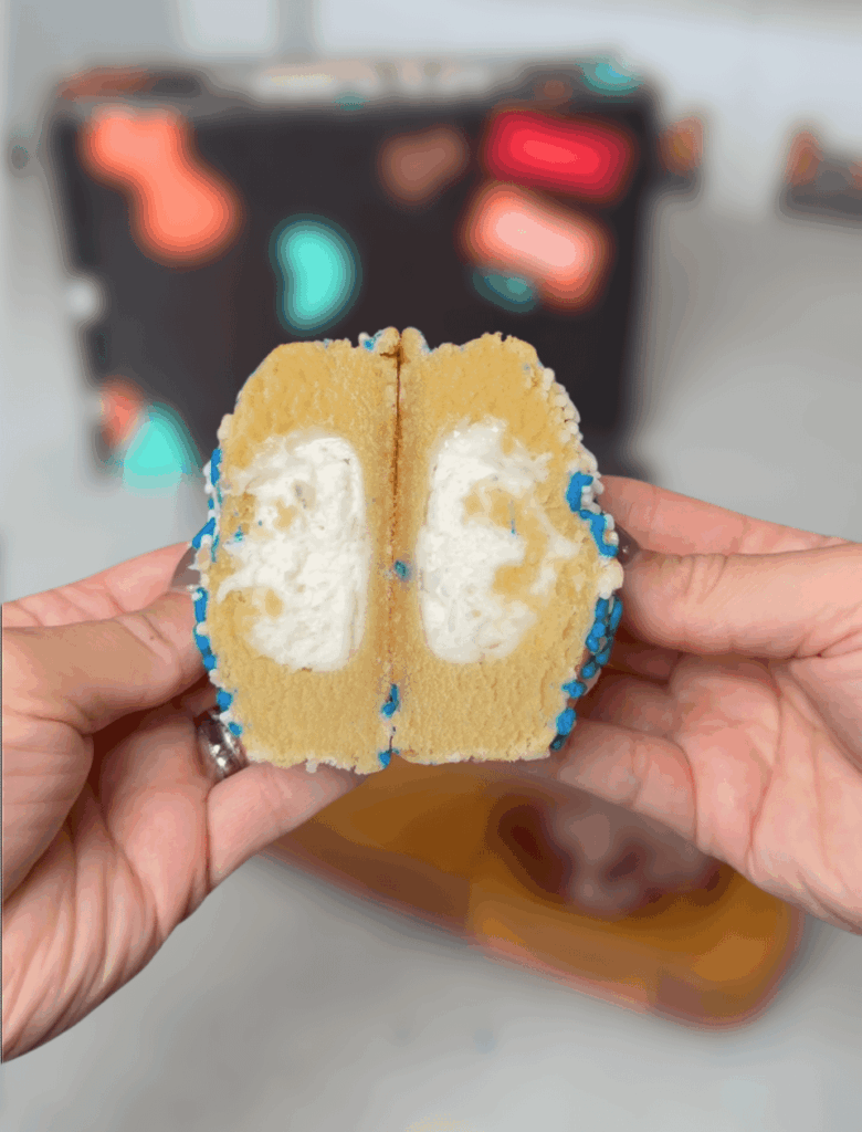 Delicious classic sugar cookie dough base stuffed with sugar cookie chunks, a frosting core, and its all topped with blue and white sprinkles.