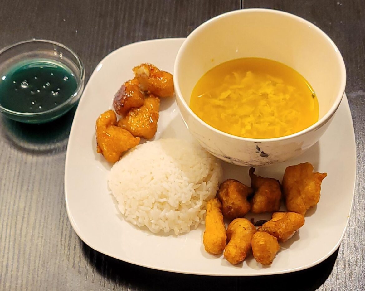 Sweet and sour chicken, rice, orange chicken, and egg drop soup.(blue sauce is sweet and sour)