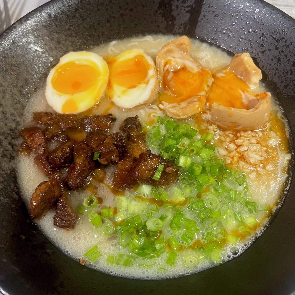 Friday night homemade tonkotsu ramen. Made the broth earlier in the year over multiple days and froze in portions. Topped with chashu bites, green onion, ramen egg (one failed- didn’t have time to wait for them to get jammy today, but still delicious) and garlic fried in sesame oil + Smala hot sauce Friday night homemade tonkotsu ramen. Made the broth earlier in the year over multiple days and froze in portions. Topped with chashu bites, green onion, ramen egg (one failed- didn’t have time to wait for them to get jammy today, but still delicious) and garlic fried in sesame oil + Smala hot sauce