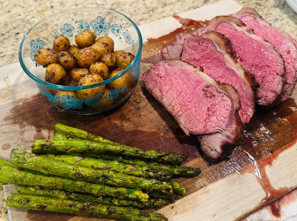 Reverse Seared NY Strip Loin served with Roasted Garlic Honey Gold Potatoes and Grilled Asparagus