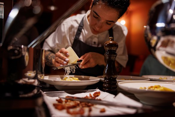 Sarah Cicolini grating pecorino on top of her carbonara.