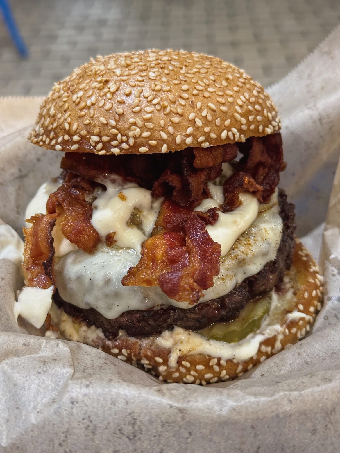 Dry aged burger with garlic confit mayo, provolone, caramelized onions, and bacon