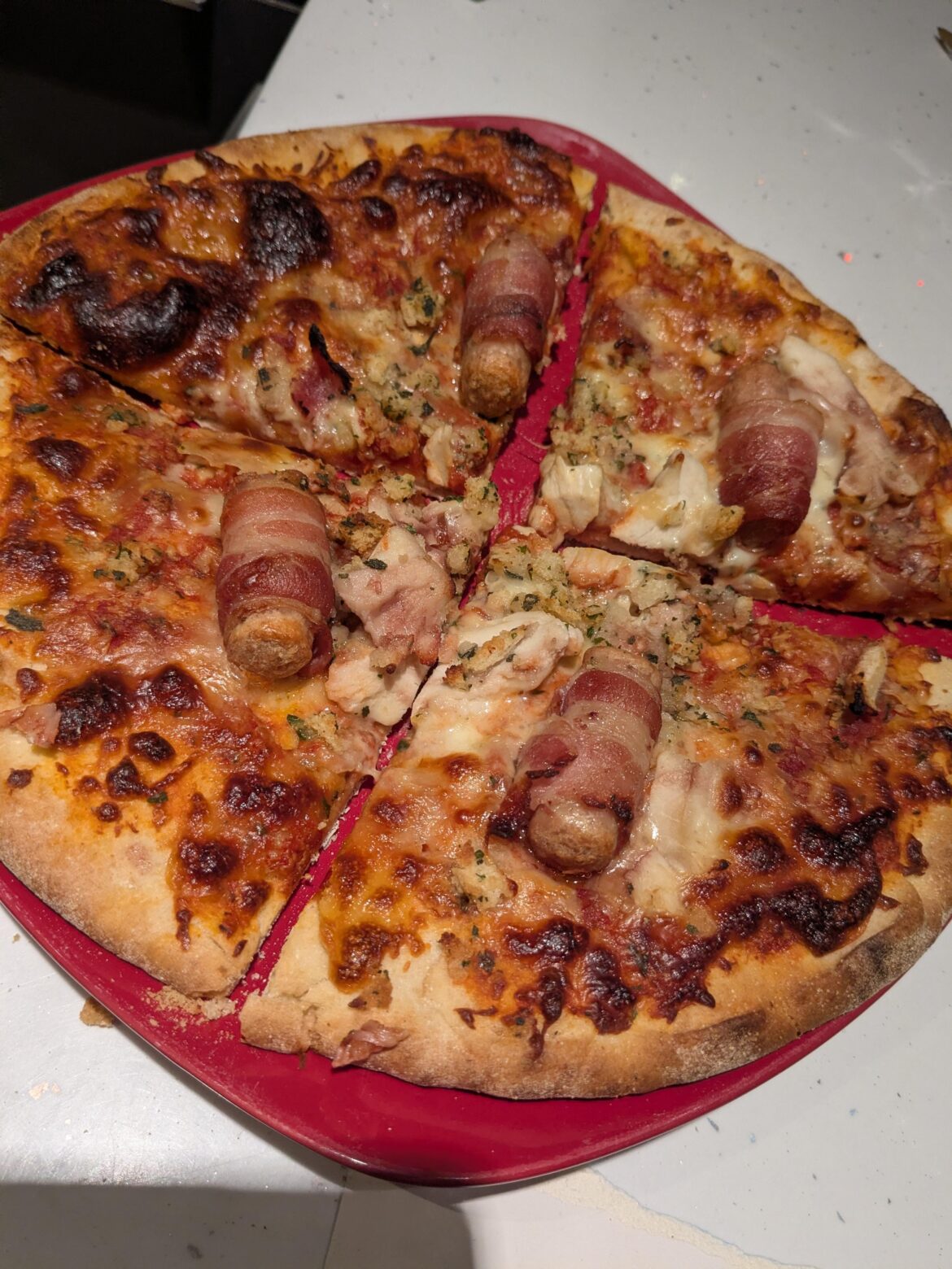 Pretty gross idea 🤣 Christmas dinner pizza .. roast chicken pigs in blankets and stuffing.. with cheese and a cranberry tomato base 🎄🤮