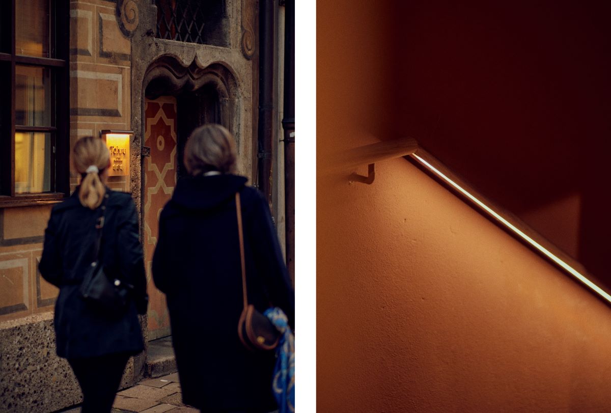 The historic entrance to Three-MICHELIN-Star Tohru in der Schreiberei and the railing of the steep wooden staircase leading up to the restaurant. © Wim Jansen/The MICHELIN Guide