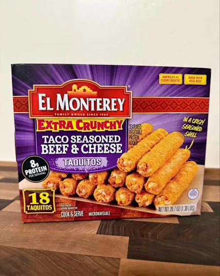Box of El Monterey Extra Crunch beef and cheese taquitos on countertop.