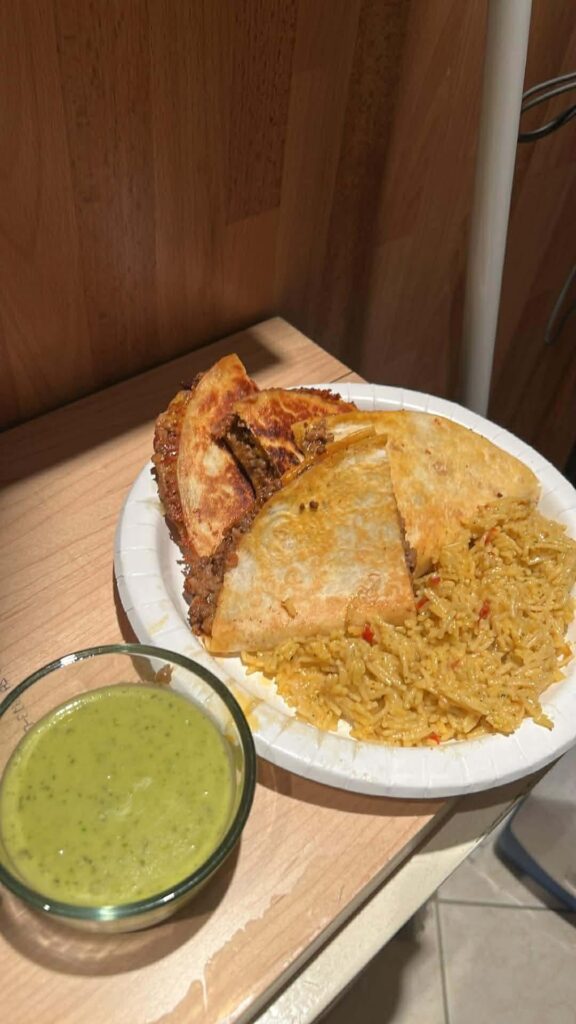 Taco meat cheese and refried bean quesadilla and guacamole sauce with Mexican rice