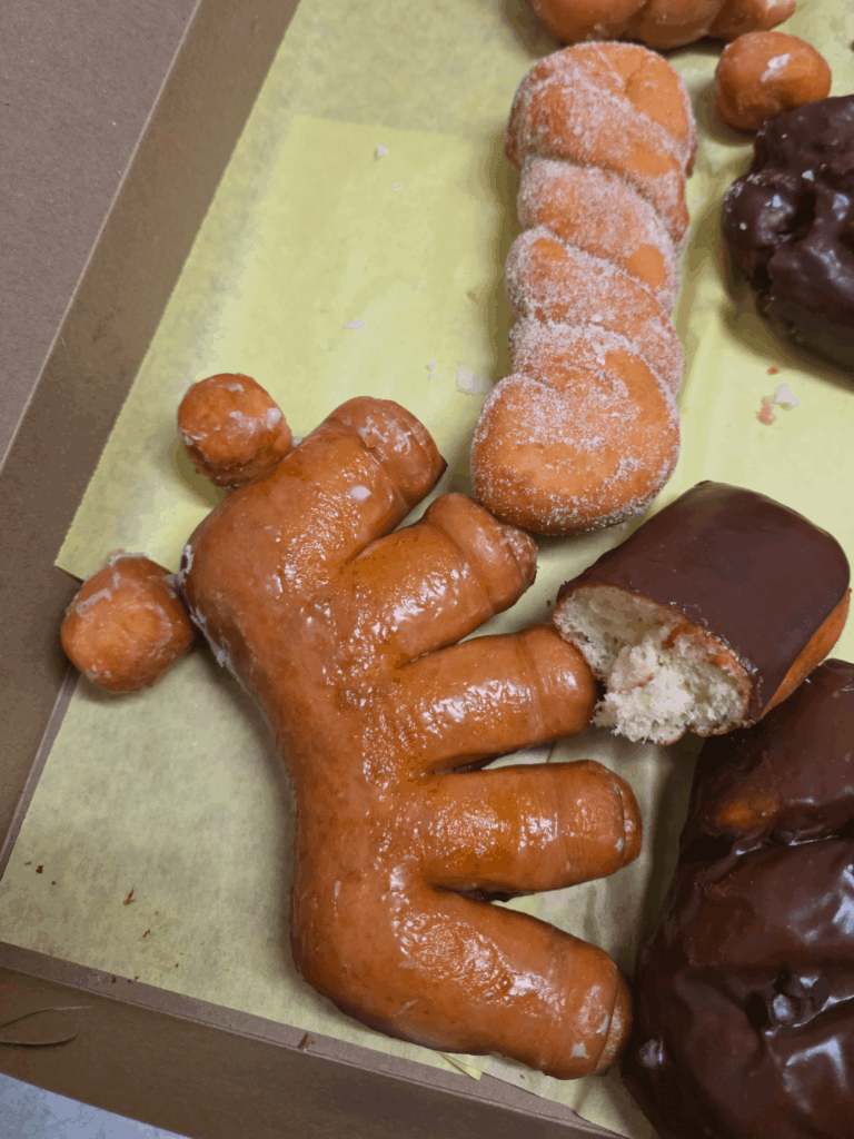 Donuts at work. No one has taken the bear claw, but everyone has stopped by to look at it.