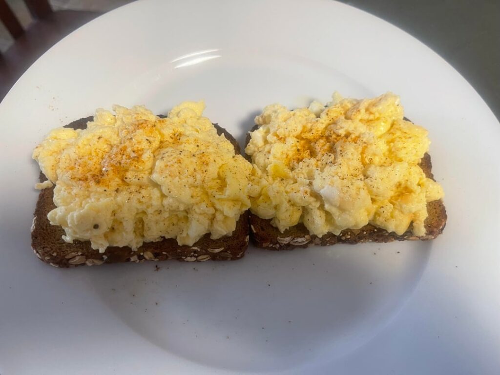 3 eggs, bunch of cottage cheese and some “New York cheddar cheese” scrambled in on toasted Dave's Killer Bread, specifically thin sliced 21 whole grain. Sprinkled Old Bay on top.