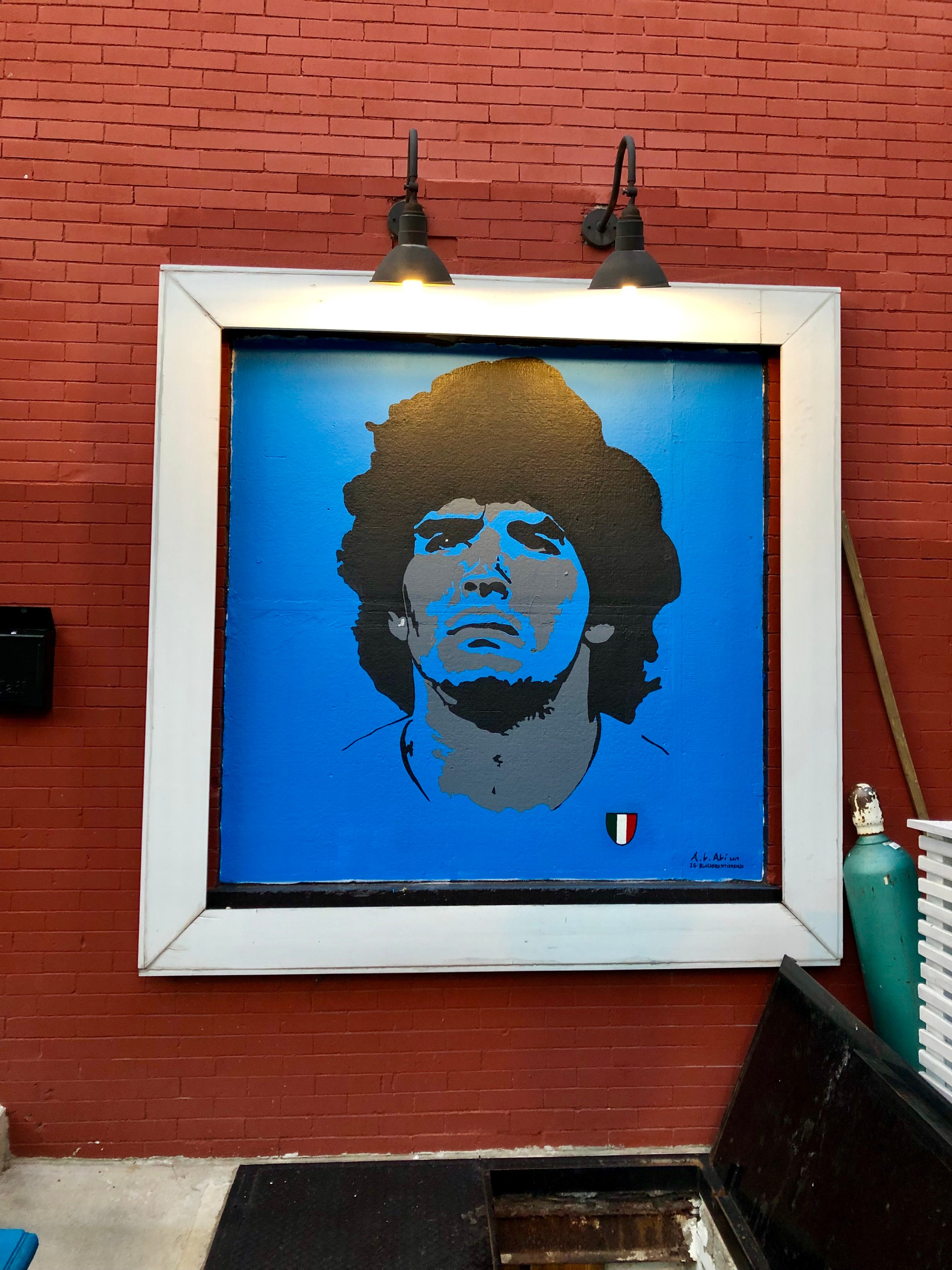 Napoli’s popular patio, lined with slick white benches and canopy lights, just got a pop of color with a royal blue mural of soccer legend Diego Armando Maradona painted by D.C. native Akeel Ali.