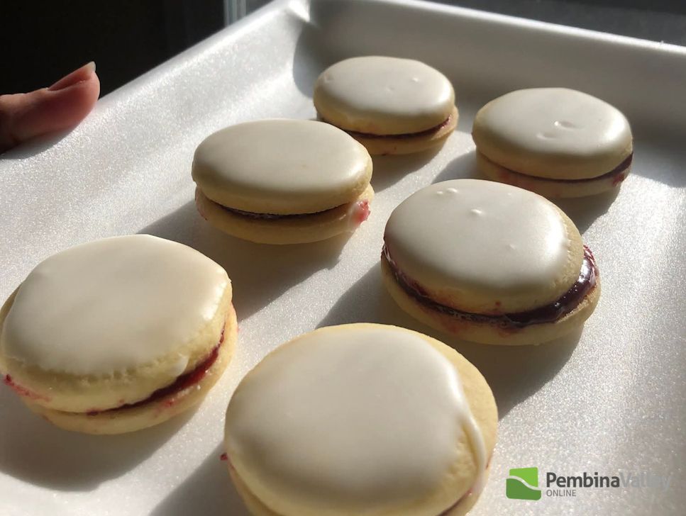 Hilda Gerbrandt (left), and younger sister Rose Froese (right), stop by the radio station with a tray of delicious homemade Christmas baking