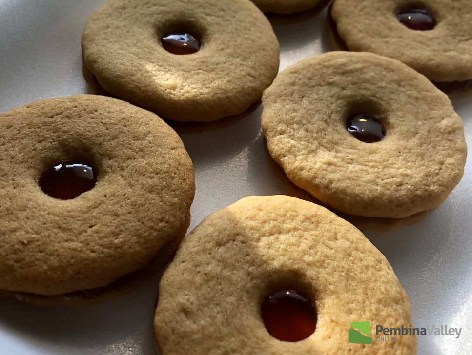 Hilda Gerbrandt (left), and younger sister Rose Froese (right), stop by the radio station with a tray of delicious homemade Christmas baking