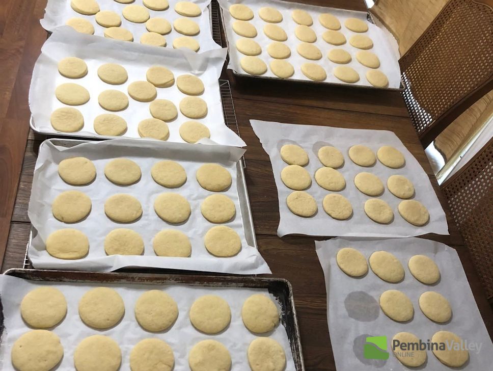 Hilda Gerbrandt (left), and younger sister Rose Froese (right), stop by the radio station with a tray of delicious homemade Christmas baking