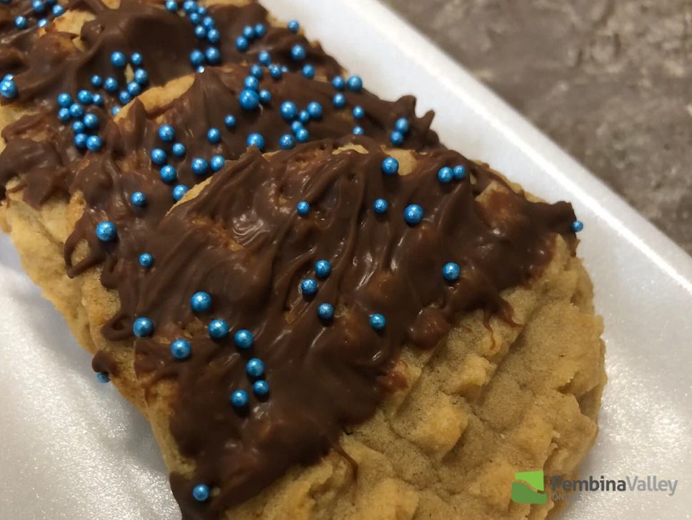 Hilda Gerbrandt (left), and younger sister Rose Froese (right), stop by the radio station with a tray of delicious homemade Christmas baking